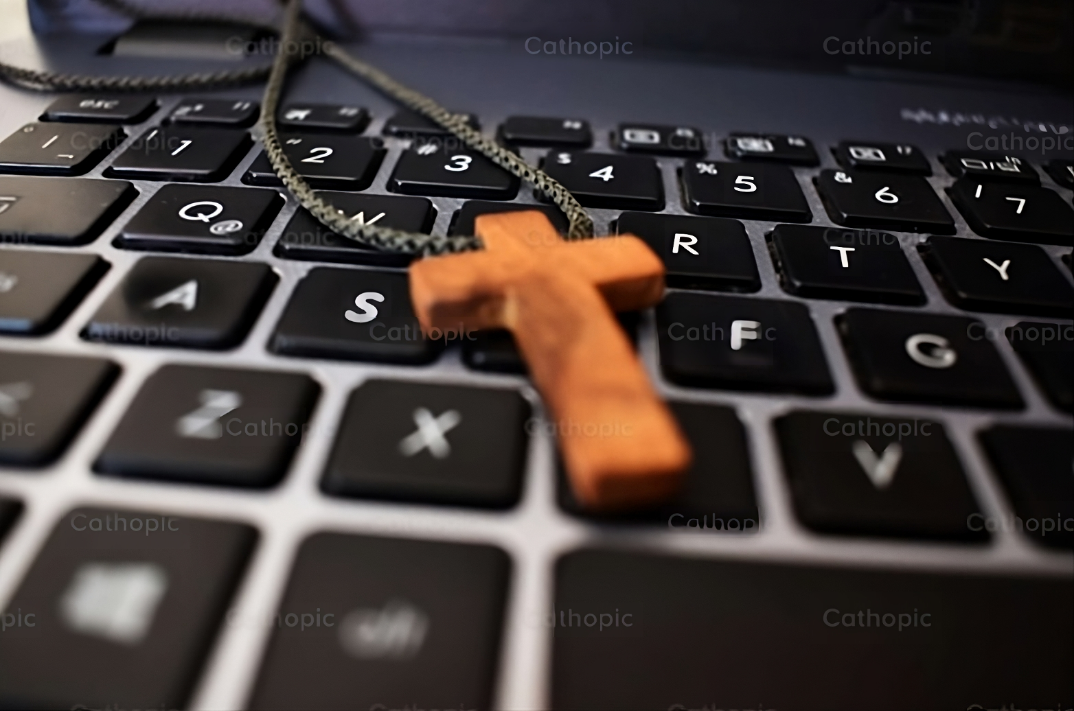 Photo of a wooden cross laying on a keyboard