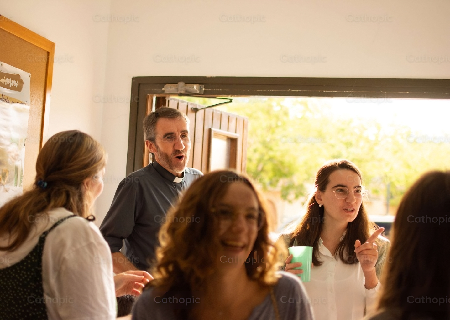 Adult Catholic students with teacher priest.