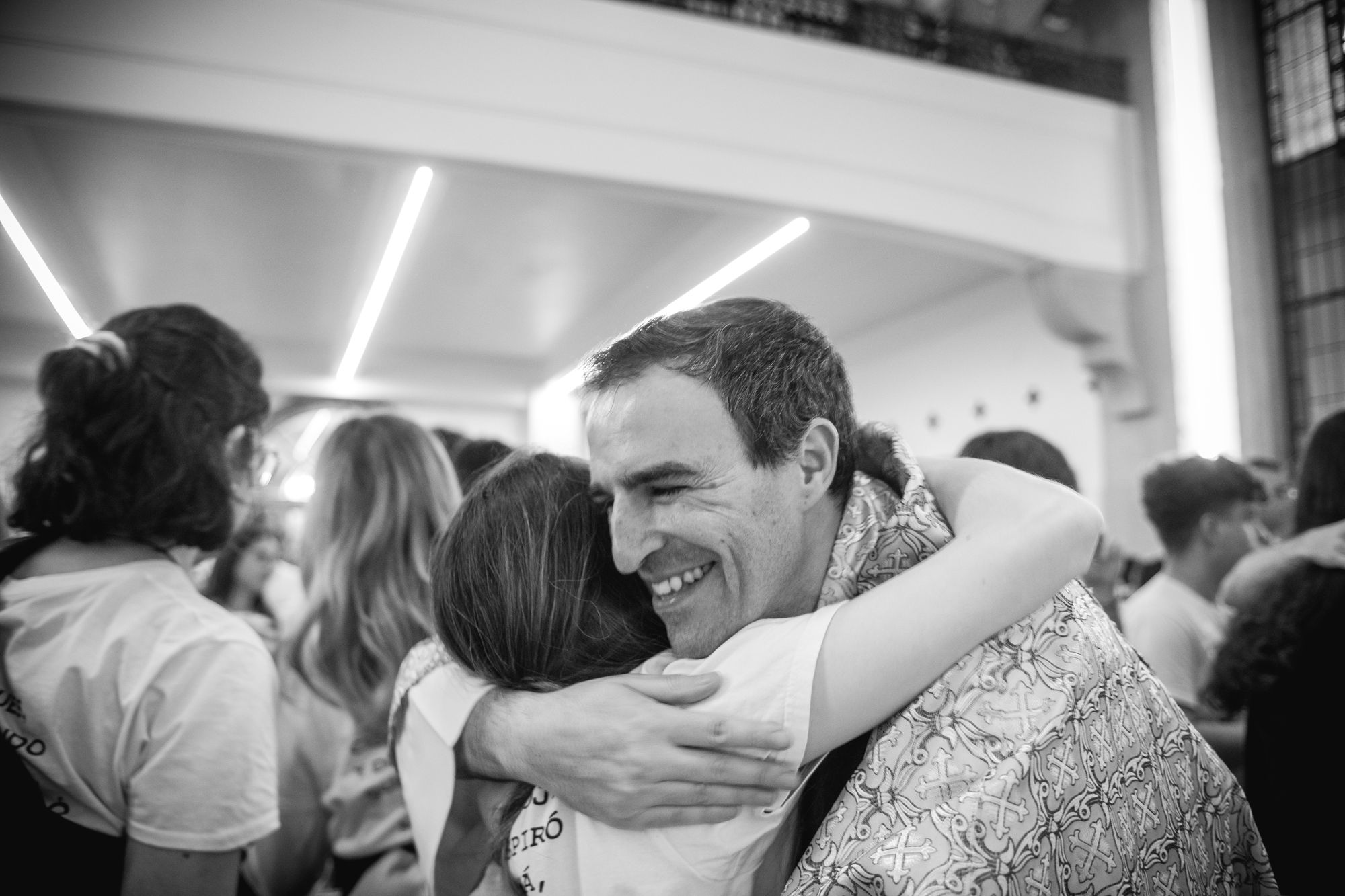 Hugging a priest.