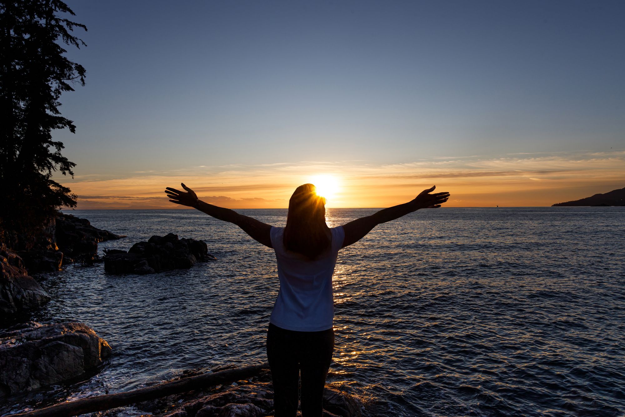 Woman embracing the setting sun