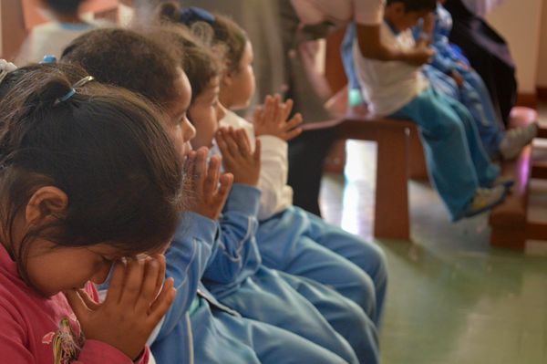 Children praying in school.