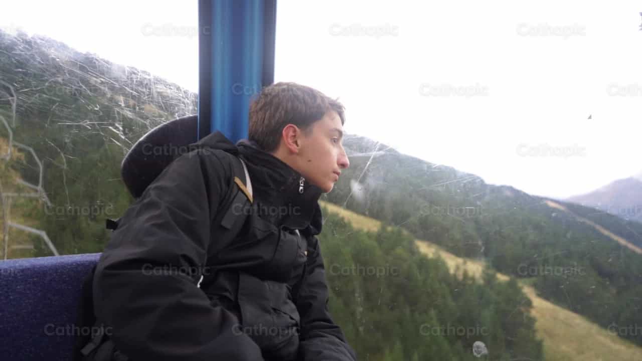 Young man on a cable car - Catholic stock videos - Photo by Lupe Belmonte