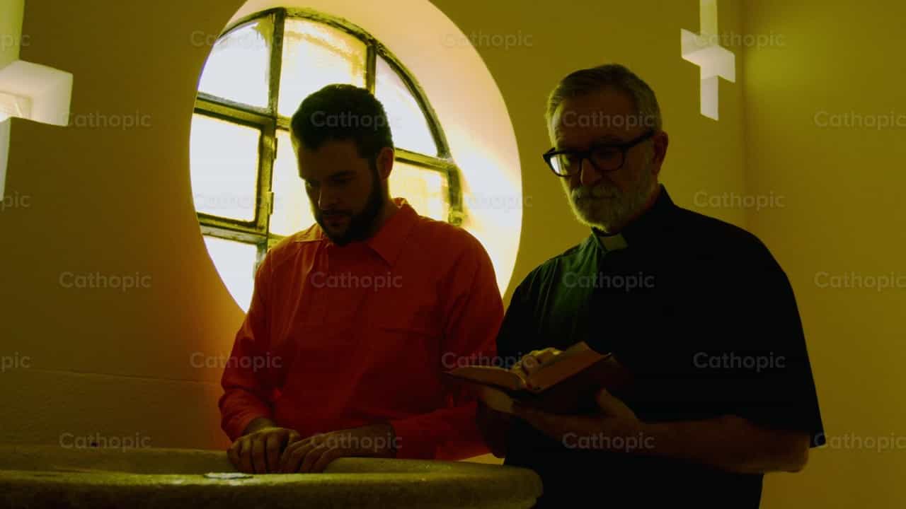 Priest accompanies a prisoner - Catholic stock videos - Photo by Almures Studio