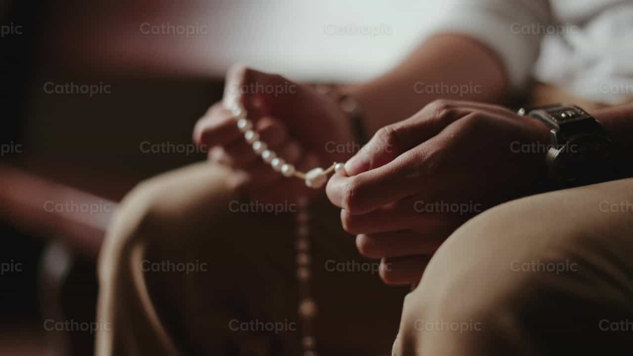 Hands of a man praying the rosary - Catholic stock videos