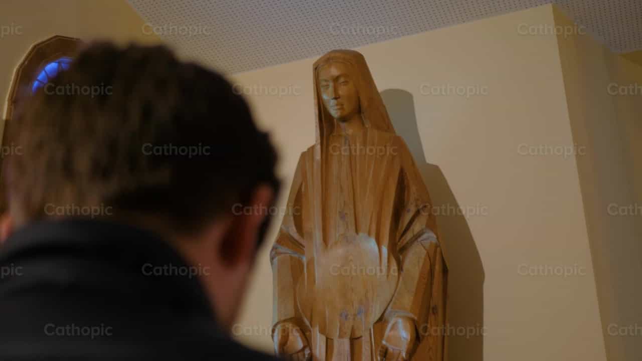 Praying before a Statue of Mary - Catholic stock videos