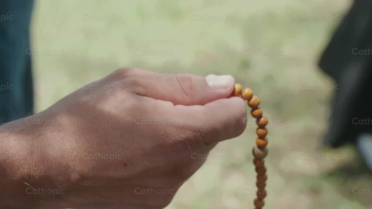 Rosary in hand - Catholic stock videos
