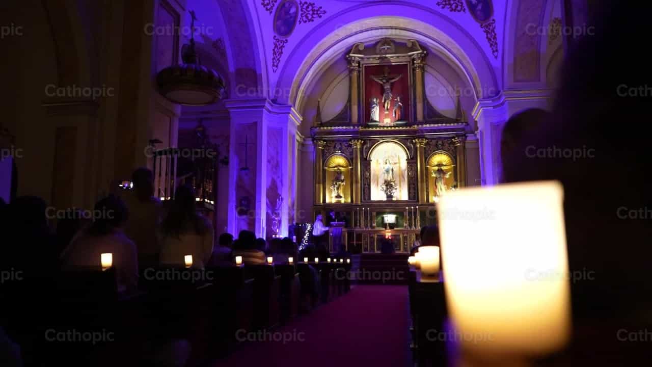 Community praying with candles - Catholic stock videos - Photo by Iván W. Jaques