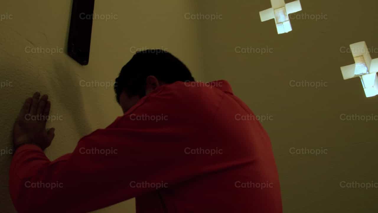 Prisoner before a crucifix - Catholic stock videos - Photo by Almures Studio