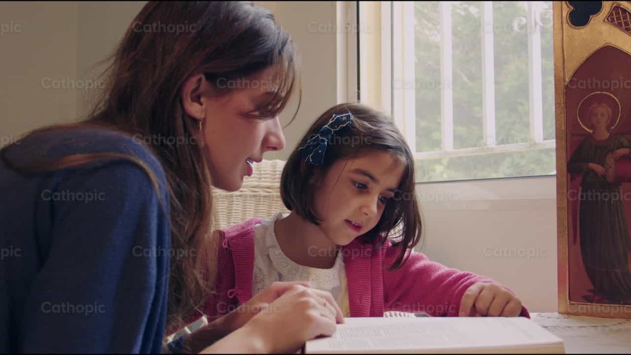 Mother and daughter reading the Bible - Catholic stock videos - Photo by Almures Studio