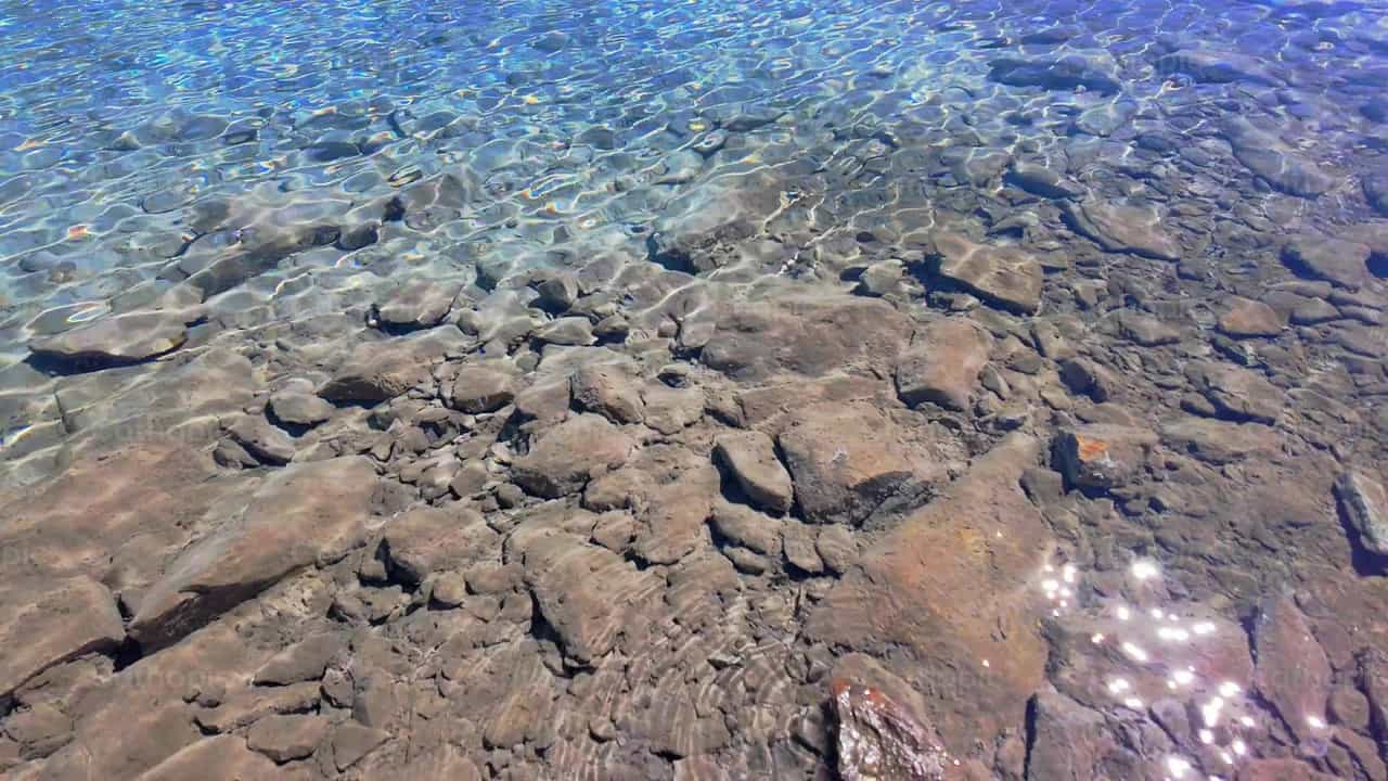 Sunlight Reflecting on Clear Rocky Water of Mounta - Catholic stock videos