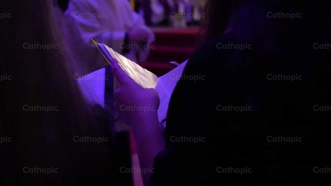 Songbook in the hands of a woman - Catholic stock videos - Photo by Iván W. Jaques