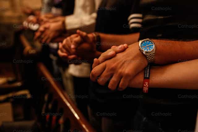 Young people united in prayer - Catholic stock images