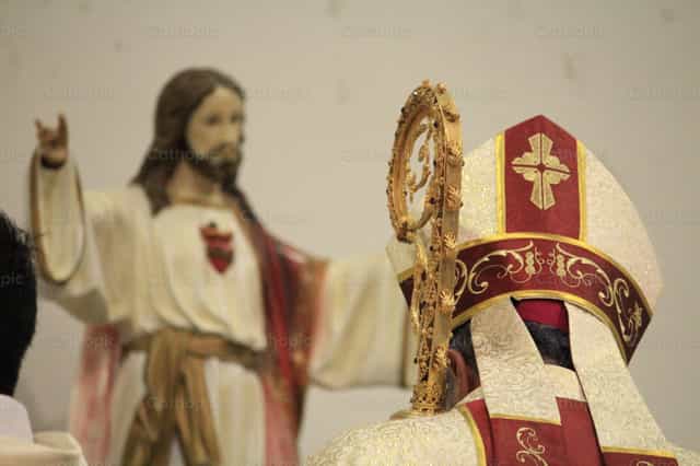 Bishop and statue of the Sacred Heart - Catholic stock images