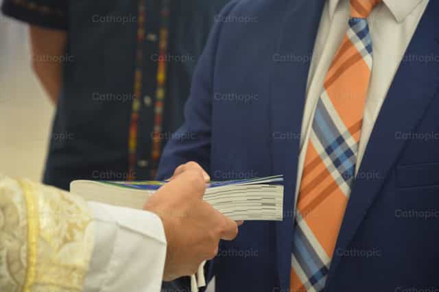 Layman receiving Bible - Catholic stock images