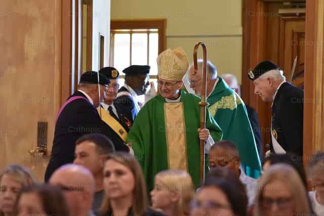 Bishop Raica greeting parishioners in a church - Catholic stock images