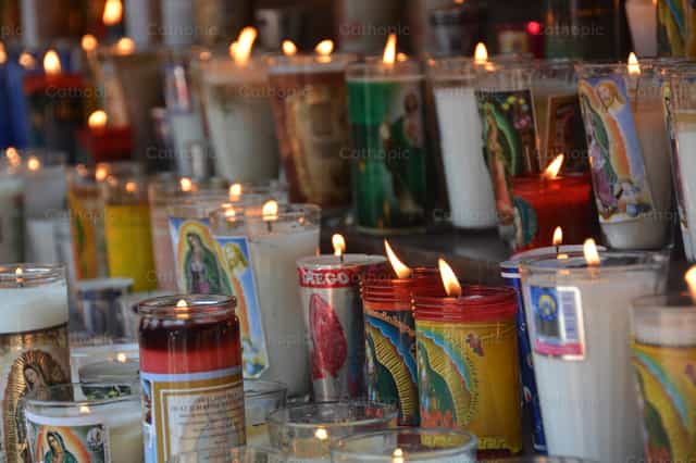 A burning candle, a petition to the Virgin Mary - Catholic stock images
