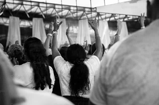 Manos extendidas hacia el altar - Banco de imágenes católicas - Fotografía por Carolina BR