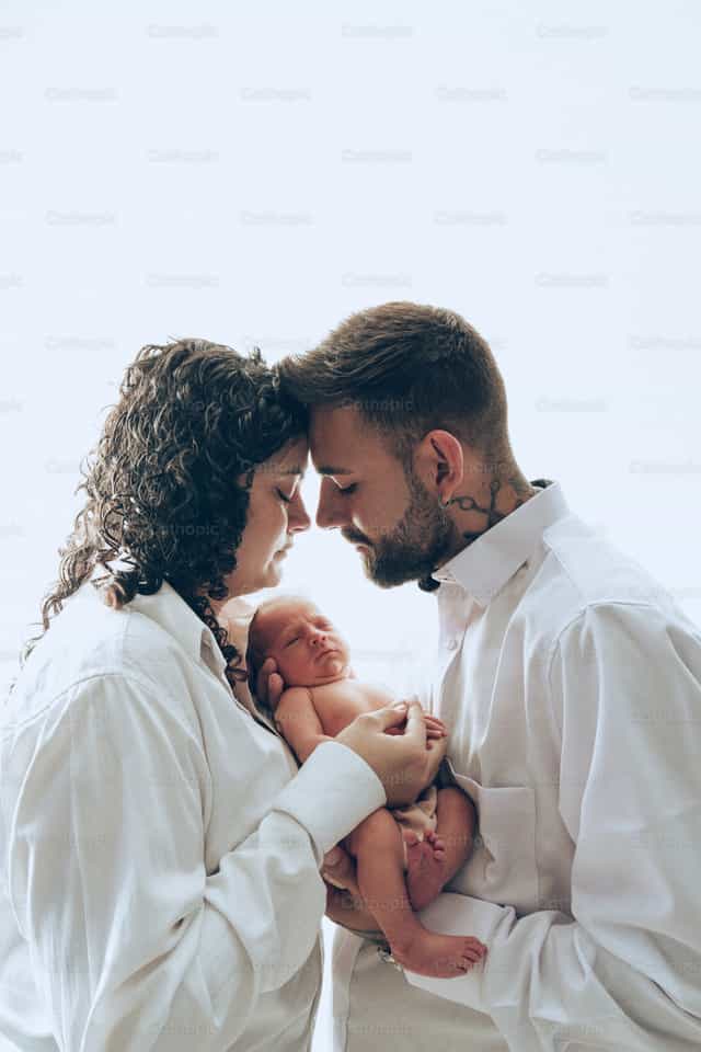 Baby in its parents' arms - Catholic stock images - Photo by Clina CG