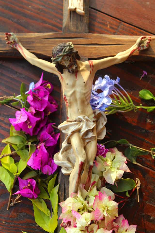 Cross surrounded by flowers - Catholic stock images