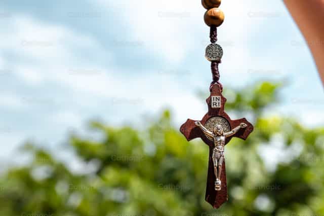 Close-Up of Rosary Crucifix With Nature Background - Catholic stock images - Photo by Piero Insfran