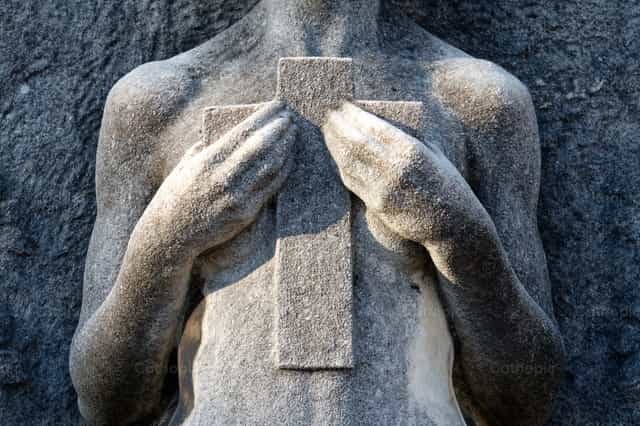 Funeral art statue in a Christian cemetery - Catholic stock images - Photo by Joan Sutter