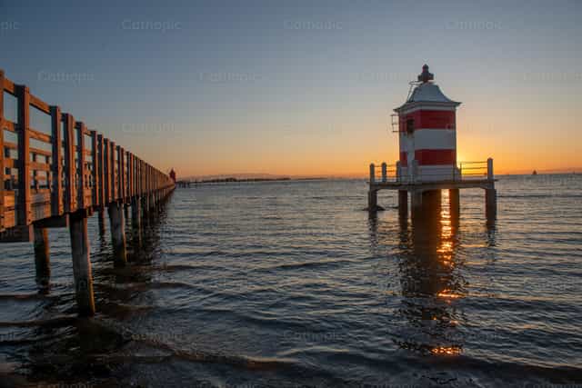 The old red lighthouse of Lignano Sabbiadoro at sunrise - Catholic stock images - Photo by Pierluigi Palazzi