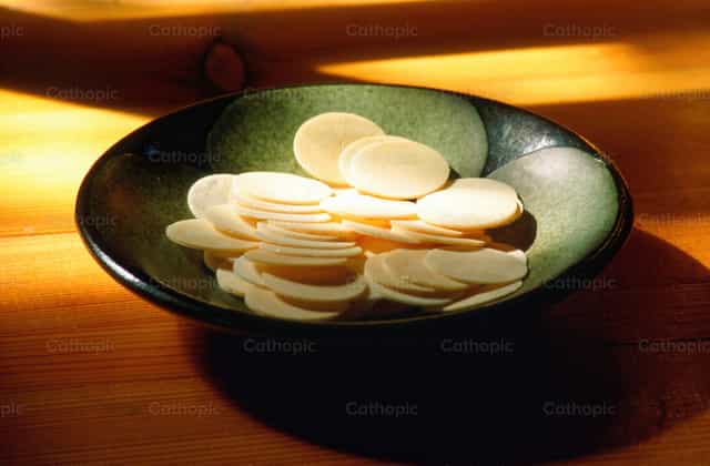 Communion hosts on paten - Catholic stock images - Photo by Joan Sutter