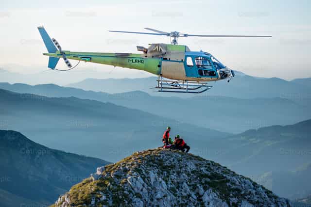 Helicóptero con rescatistas de montaña recuperando a una persona herida. - Banco de imágenes católicas - Fotografía por Pierluigi Palazzi
