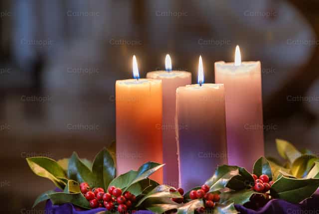 Christmas candles lit - Catholic stock images - Photo by Pierluigi Palazzi