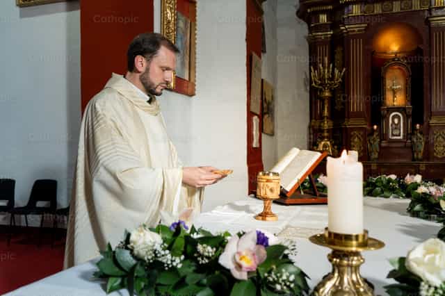 Priest holding the Host - Catholic stock images - Photo by Clina CG