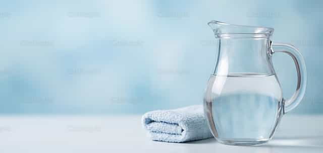 Jarra de agua de cristal y toallas: ritual del lavado de pies - Banco de imágenes católicas