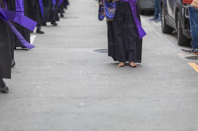 A barefoot penitent in a procession - Catholic stock images - Photo by Yandry Fernández Perdomo