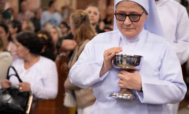 Religiosa con copón durante celebración eucarístic - Banco de imágenes católicas - Fotografía por Carolina BR