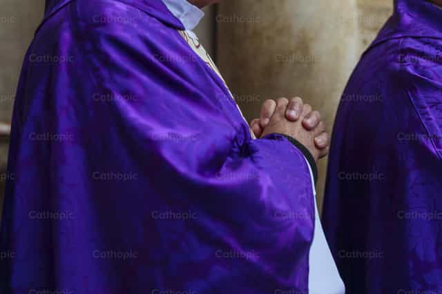 Manos de sacerdote en oración con casulla morada - Banco de imágenes católicas - Fotografía por Diócesis de Córdoba