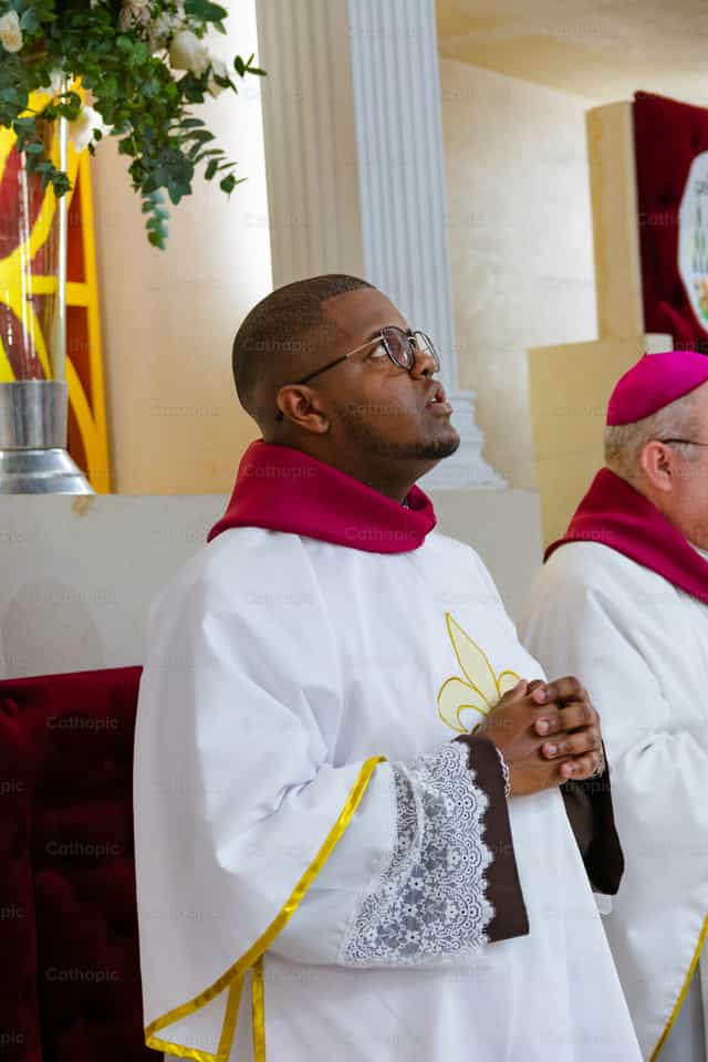 A deacon looking up at the sky, praying to God - Catholic stock images - Photo by Miguel White