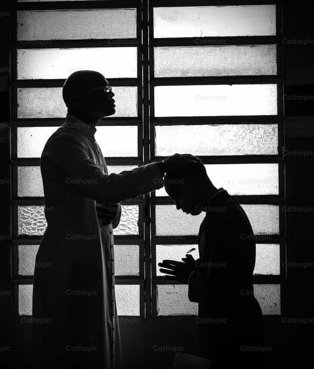 Priest confessing - Catholic stock images