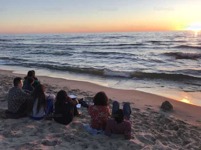 Contemplating the ocean with friends - Catholic stock images