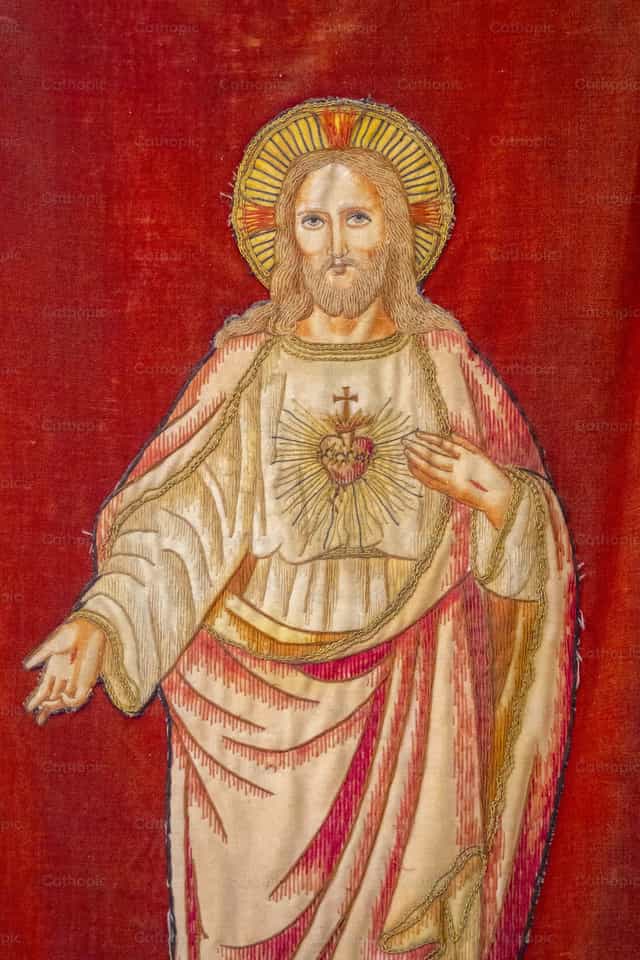 Embroidered textile banner with the Sacred Heart - Catholic stock images