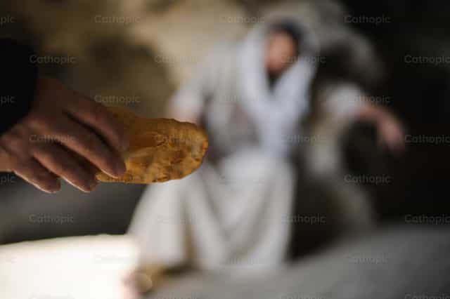 The devil tempts Jesus with bread in the wildernes - Catholic stock images