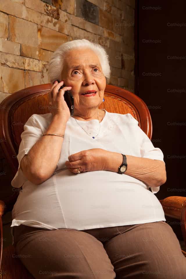 Grandma Isabel talking on the cell phone - Catholic stock images - Photo by Clina CG