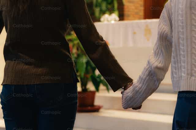 Hands united in multicultural prayer - Catholic stock images - Photo by Almures Studio