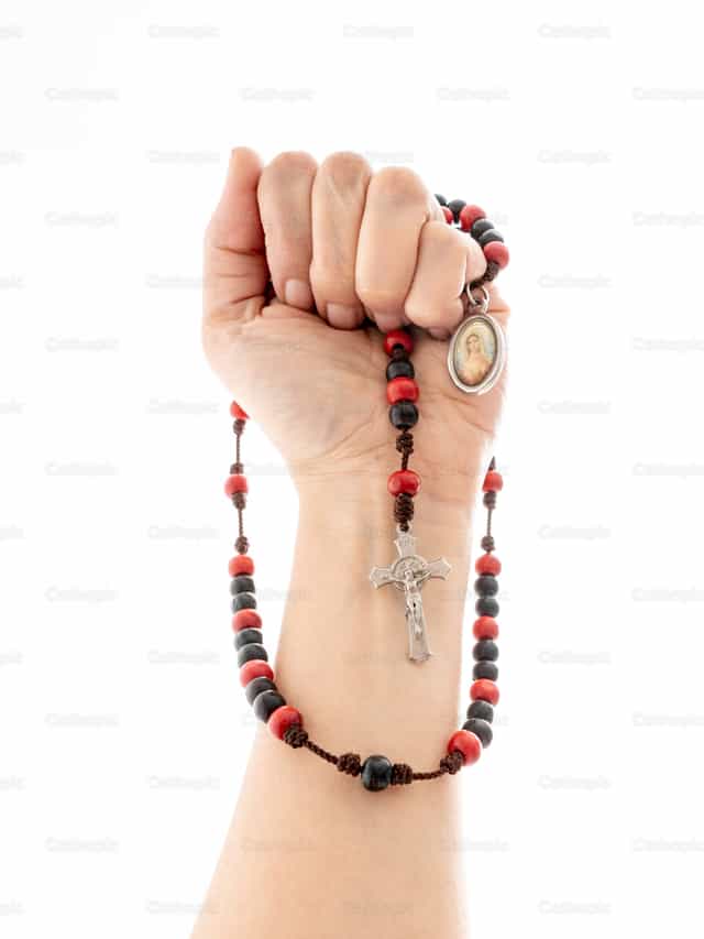 Rosary in a woman's hand - Catholic stock images