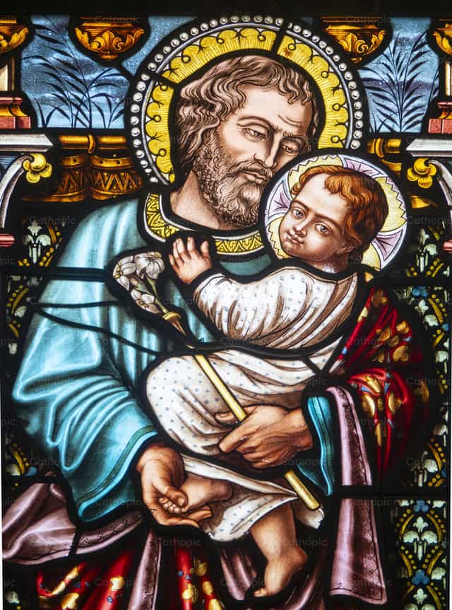 Der heilige Josef hält das Jesuskind in seinen Armen - Katholische Stockfotos
