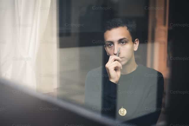Salesian brother and a medal - Catholic stock images - Photo by Vytautas Markūnas SDB