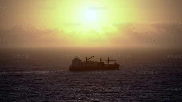 Barco ao pôr do sol - Imagens católicas de stock