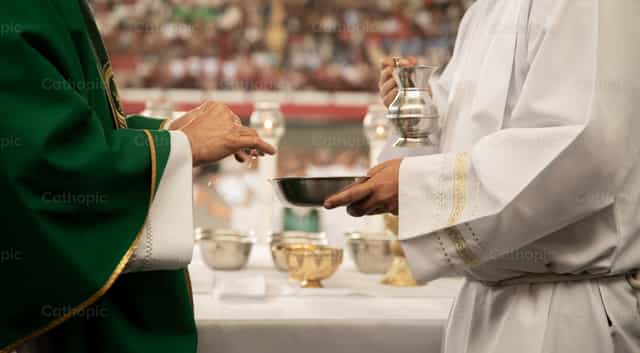 Prêtres servant à l’autel - Images catholiques de stock