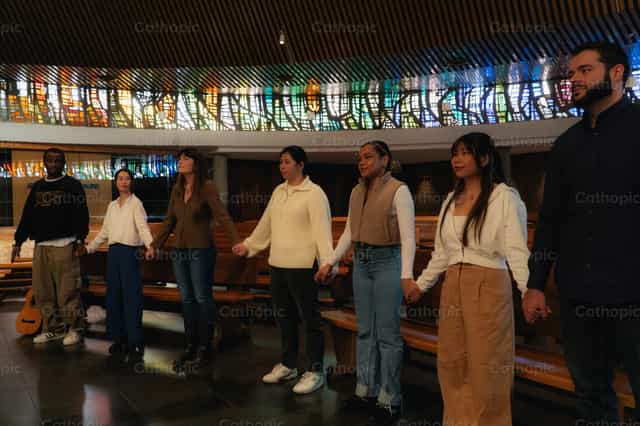 Young people praying in a Multicultural Encounter - Catholic stock images - Photo by Almures Studio