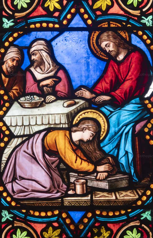 Stained-glass window depicting Jesus and the sinful woman - Catholic stock images - Photo by Joan Sutter