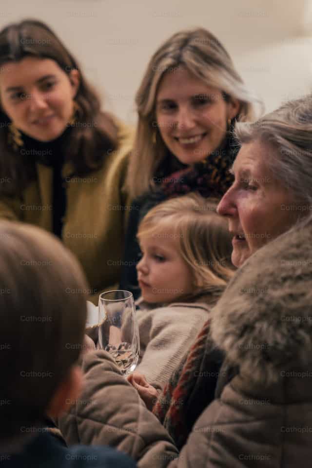 Family gathered for Christmas dinner - Catholic stock images - Photo by Almures Studio