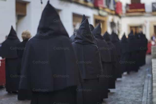 Nazarenes in black robes - Catholic stock images